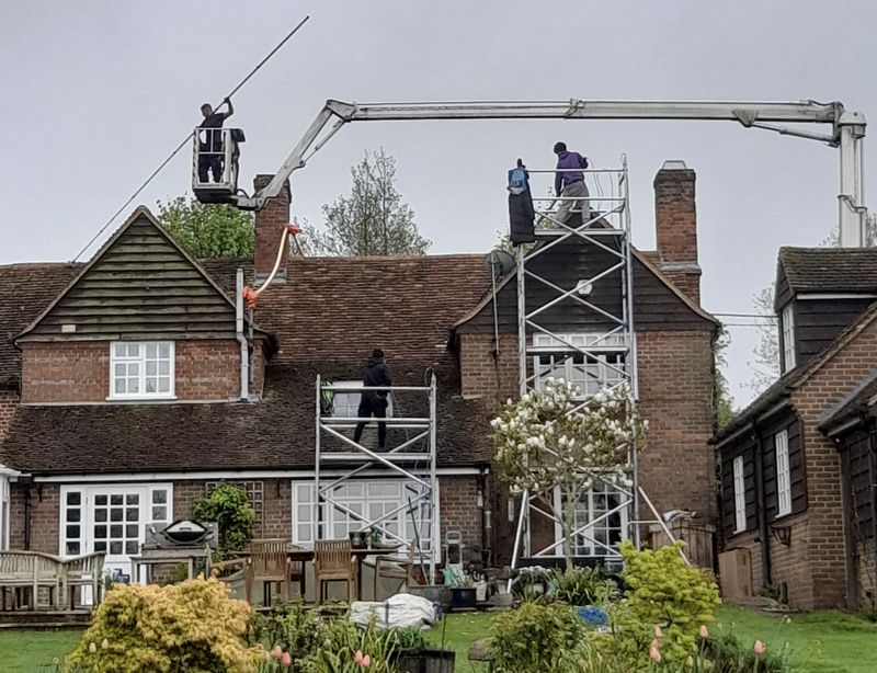 The Roof Moss Cleaners using cherry picker and scaffolding to clean roof safely and professionally in Malmesbury, Wiltshire